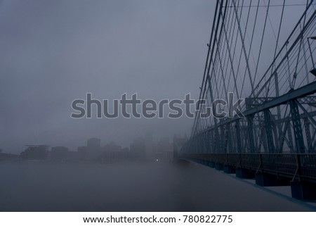 cincinnati, Ohio and covington Kentucky riverfront and skyline with bridges in the fog on a misty day 