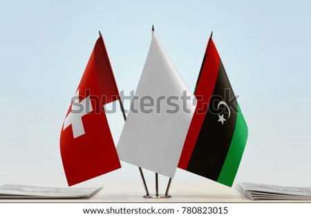 Flags of Switzerland and Libya with a white flag in the middle