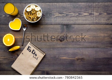 Good morning habits. Eat porridge and fruits and make to do list. Dark wooden background top view copyspace