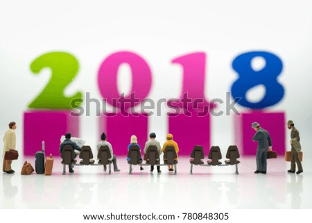 Miniature people : Businesses team waiting for travel and colorful wood number 2018 with copy space using as business trip traveler adviser agency or online world wide marketing, new year concept.