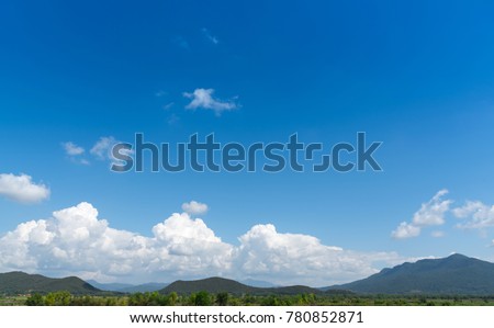 Copy space with mountain, blue sky and white cloud background. Nature environment concept. Shallow depth of field. Sky and clouds in summer time.