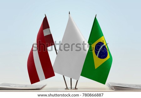 Flags of Latvia and Brazil with a white flag in the middle