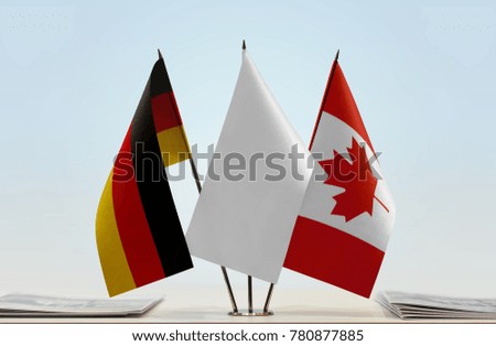 Flags of Germany and Canada with a white flag in the middle