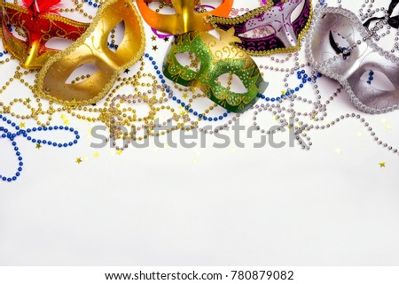 Festive Carnival background with masks, beads and copy space. Carnivale mask on a white background. 