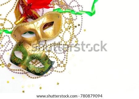 Mardi Gras background with masks, beads and copy space. Carnivale mask on a white background. 