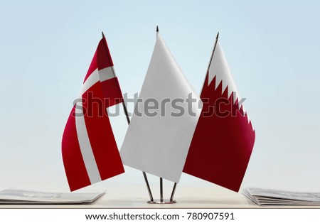 Flags of Denmark and Qatar with a white flag in the middle