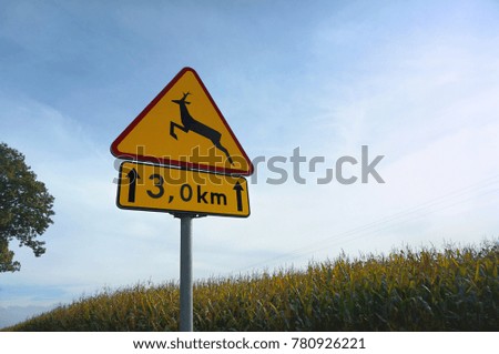 road warning sign "beware of animals crossing traffic"