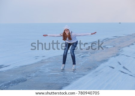 Beautiful girl on lake Baikal in winter, ice