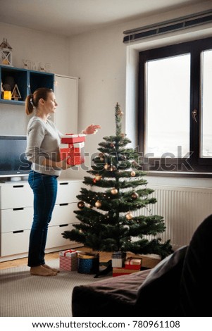 beatiful woman decorating christmas tree