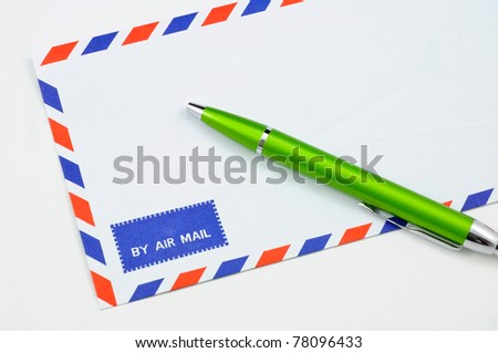 Isolated close up front of air mail envelope with a pen