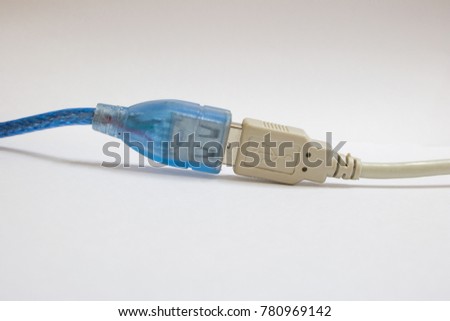 Connecting  blue USB cable and white USB cable on white background