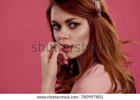   young beautiful woman on a pink background                             