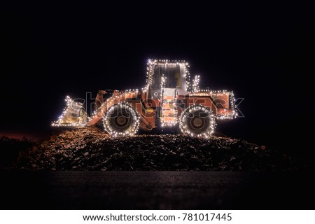 Blurred wheel loader decorated with lights