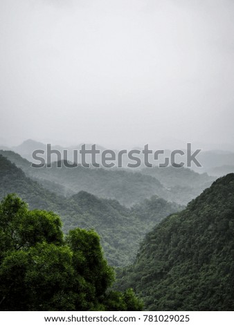 Green mountain with raining cloud