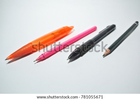 Photography of orange pen , pink pen , black pen and pencil objects on the white background with 300 Dpi format