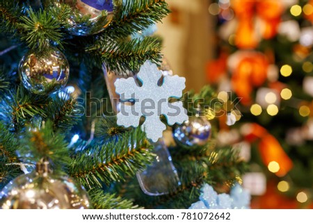 Concept New Year celebration background. Closeup photo of  christmas tree decorated with Christmas toys 