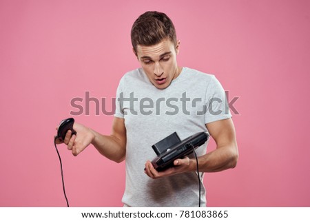  man with a game console on a pink background, technology, ps4, playstation                              