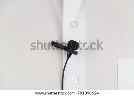 Lavalier microphone on white man's shirt