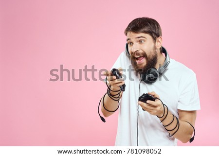  joyful men with headphones and joysticks on a pink background, studio, playstation, technology, ps4                              