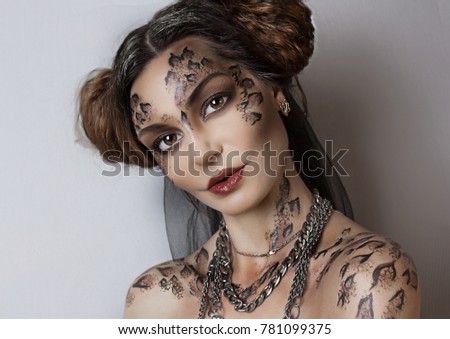 close up portrait of beautiful girl. black face painting . professional creative makeup.