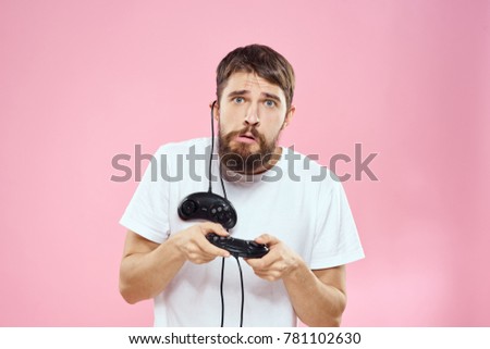 man with joysticks on a pink background, game in the console                               