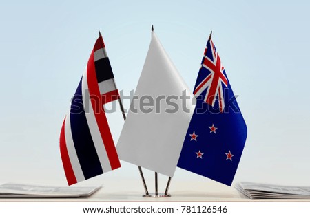 Flags of Thailand and New Zealand with a white flag in the middle
