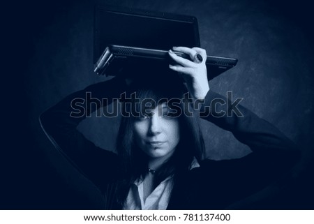Girl with laptop posing over grey background