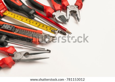 tool set of various instruments for house renovation and hand work on white background. set of hand tools including clamp, screwdrivers and other. red tool set and instruments for hand work and fixing