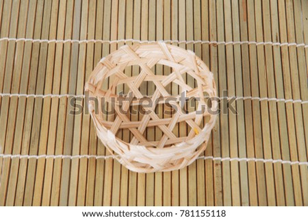 Bamboo basket on bamboo background.