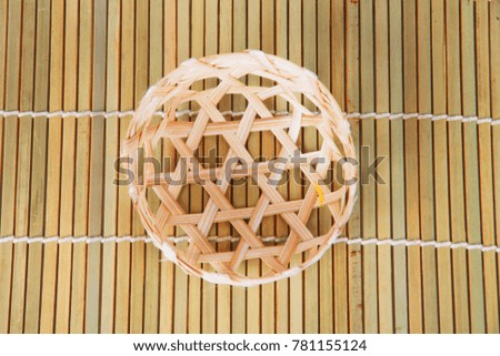 Bamboo basket on bamboo background.