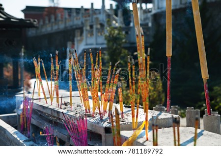 Burning incense sticks in Chinese temple. Incense for praying buddha to show respect.