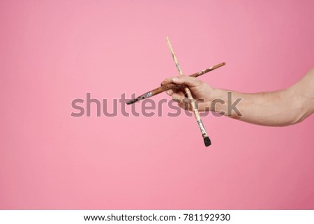 Brushes for drawing on a pink background, art                               