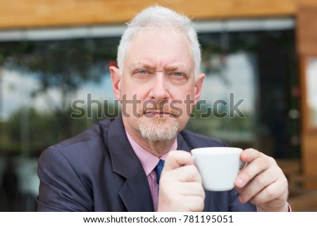 Serious Business Man Drinking Coffee Outdoors