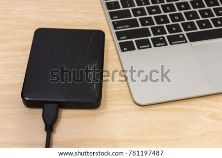 
External hard disk on laptop. 
External hard drive on keyboard.
