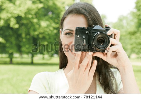 Woman taking photo with old fashioned camera.