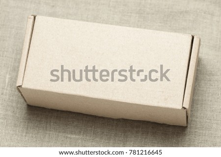 Cardboard box on a linen background. Background for mock-up