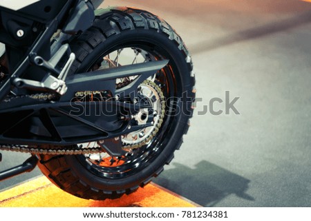 Close-up view on rear motorcycle wheel, metal spokes of wheel.