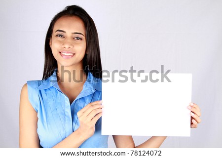 Young business woman holding empty white board.