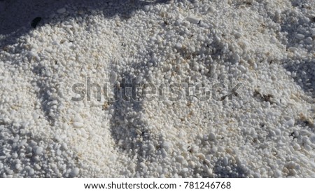marble chips on a sunny beach, sea on white beach