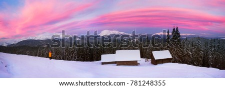 Houses of shepherds in the Carpathians, Ukraine, a tourist trek in winter gives special extreme sensations of nature on top against the backdrop high ridge of Chernogory from Goverla
