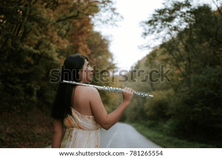 woman with a flute standing on the road