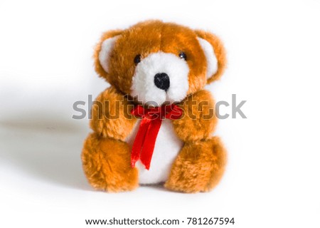 a bear stuffed animal with a red ribbon on isolated white background