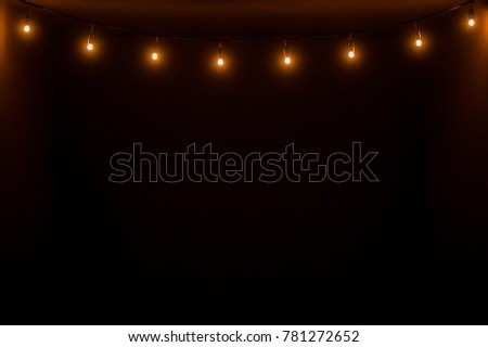 A lot of small light bulbs in a row. Free copy space text for banner. Blur light bulbs background. 