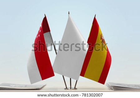 Flags of Singapore and Spain with a white flag in the middle