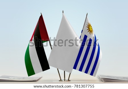 Flags of Palestine and Uruguay with a white flag in the middle