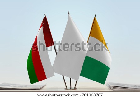 Flags of Oman and Ivory Coast with a white flag in the middle