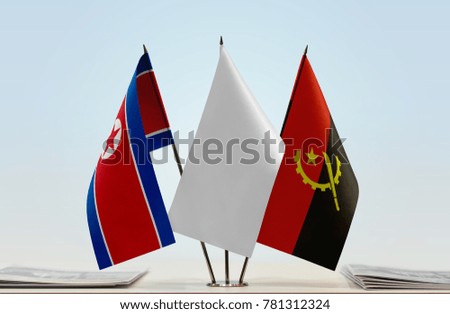 Flags of North Korea and Angola with a white flag in the middle