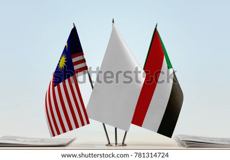 Flags of Malaysia and Sudan with a white flag in the middle