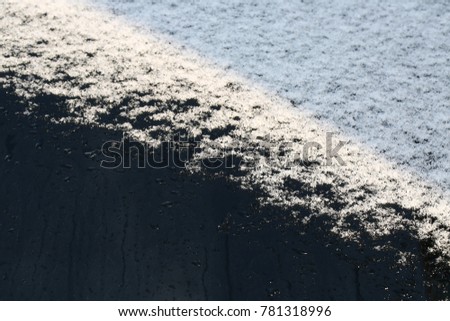 White snow melts on a window
