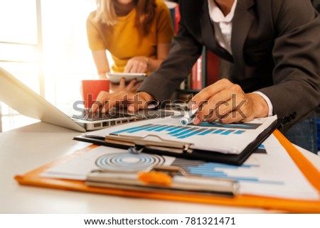 Working team meeting concept,businessman using smart phone and laptop and digital tablet computer in modern office with virtual interface icons network diagram at modern office in morning light
